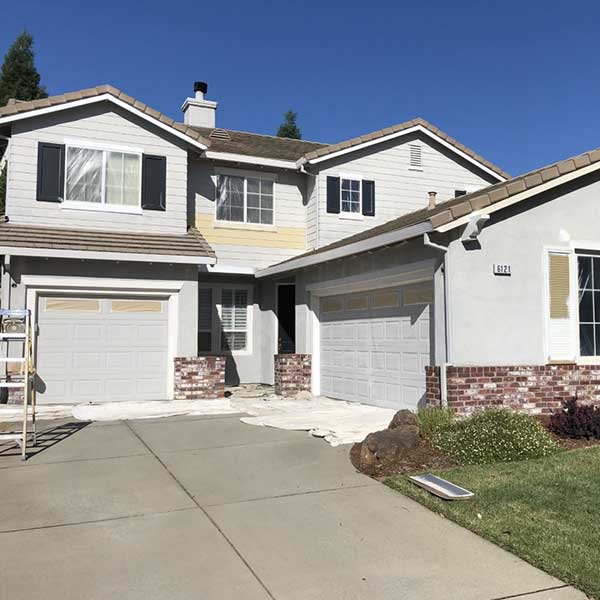 photo of two story home before being repainted